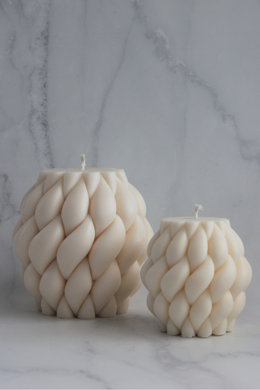 Handcrafted Tapestry Candles in small and large sizes, made from natural soy wax with a sculptural woven design